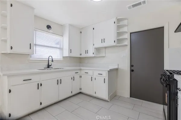 a kitchen with stainless steel appliances granite countertop a white stove top oven a sink and dishwasher