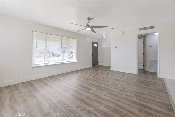 wooden floor in an empty room with a window