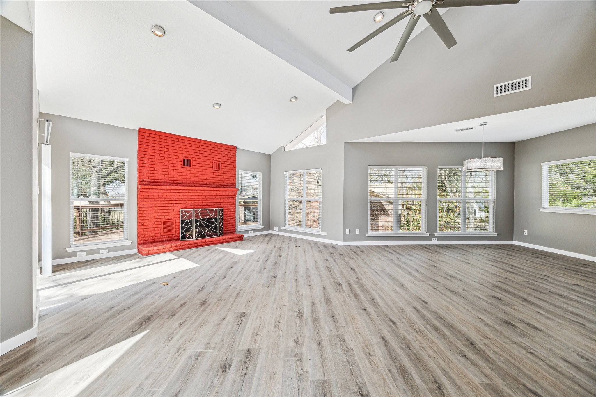 146 Dawns Edge Conroe, TX 77356 - Photo 11 of 39 an empty room with wooden floor and windows