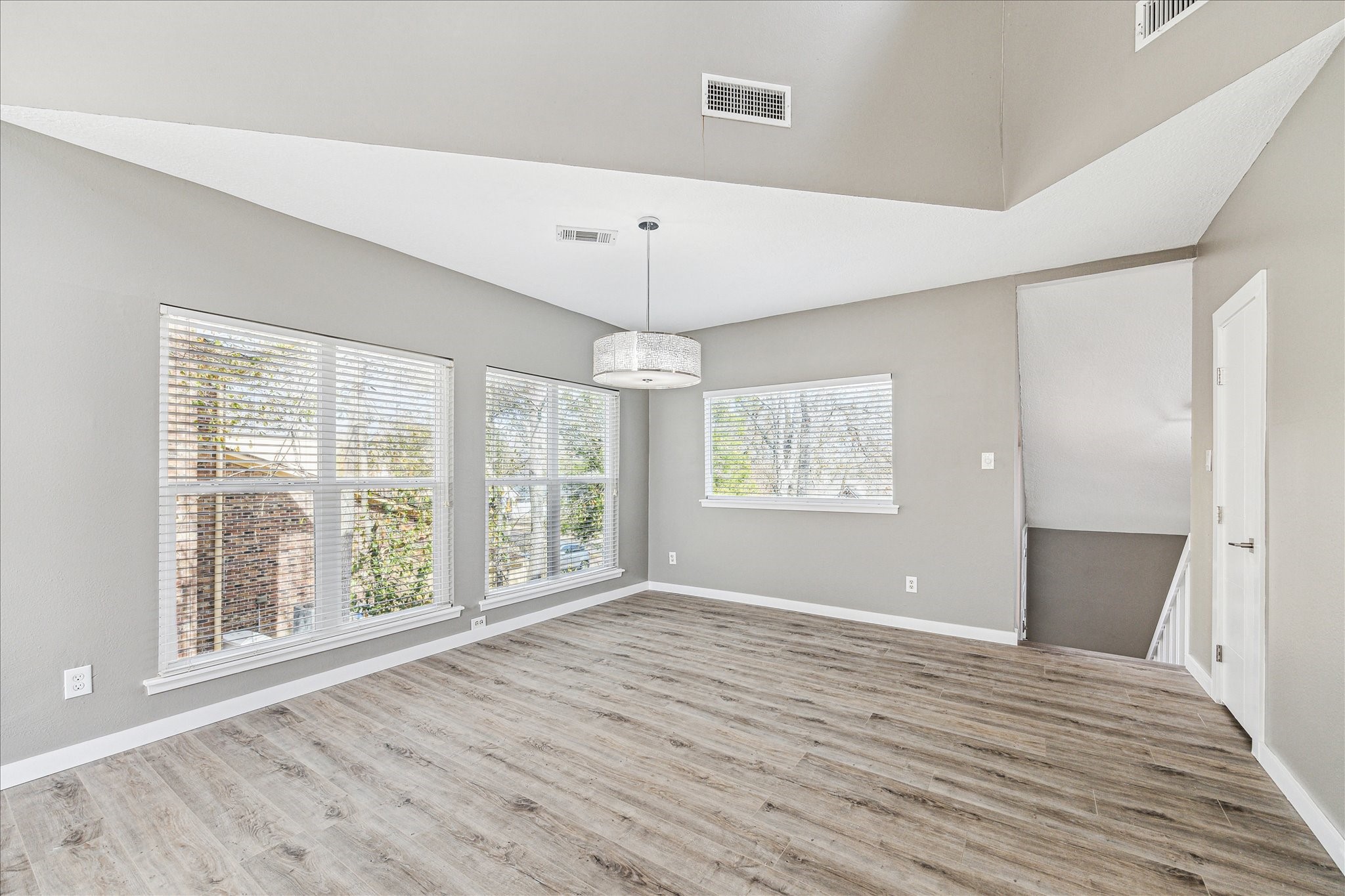 146 Dawns Edge Conroe, TX 77356 - Photo 14 of 39 a view of an empty room with wooden floor and a window