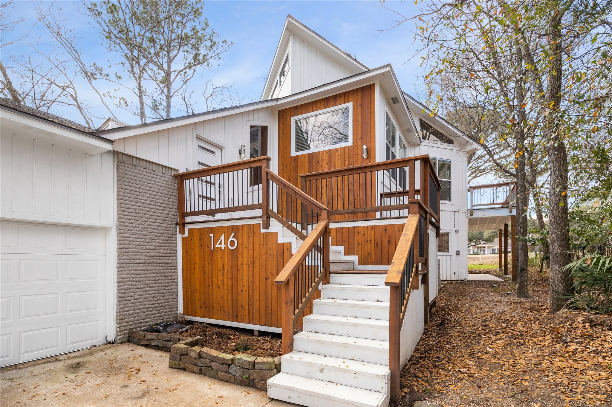 146 Dawns Edge Conroe, TX 77356 - Photo 2 of 39 a view of a white house with a large windows and flower plants