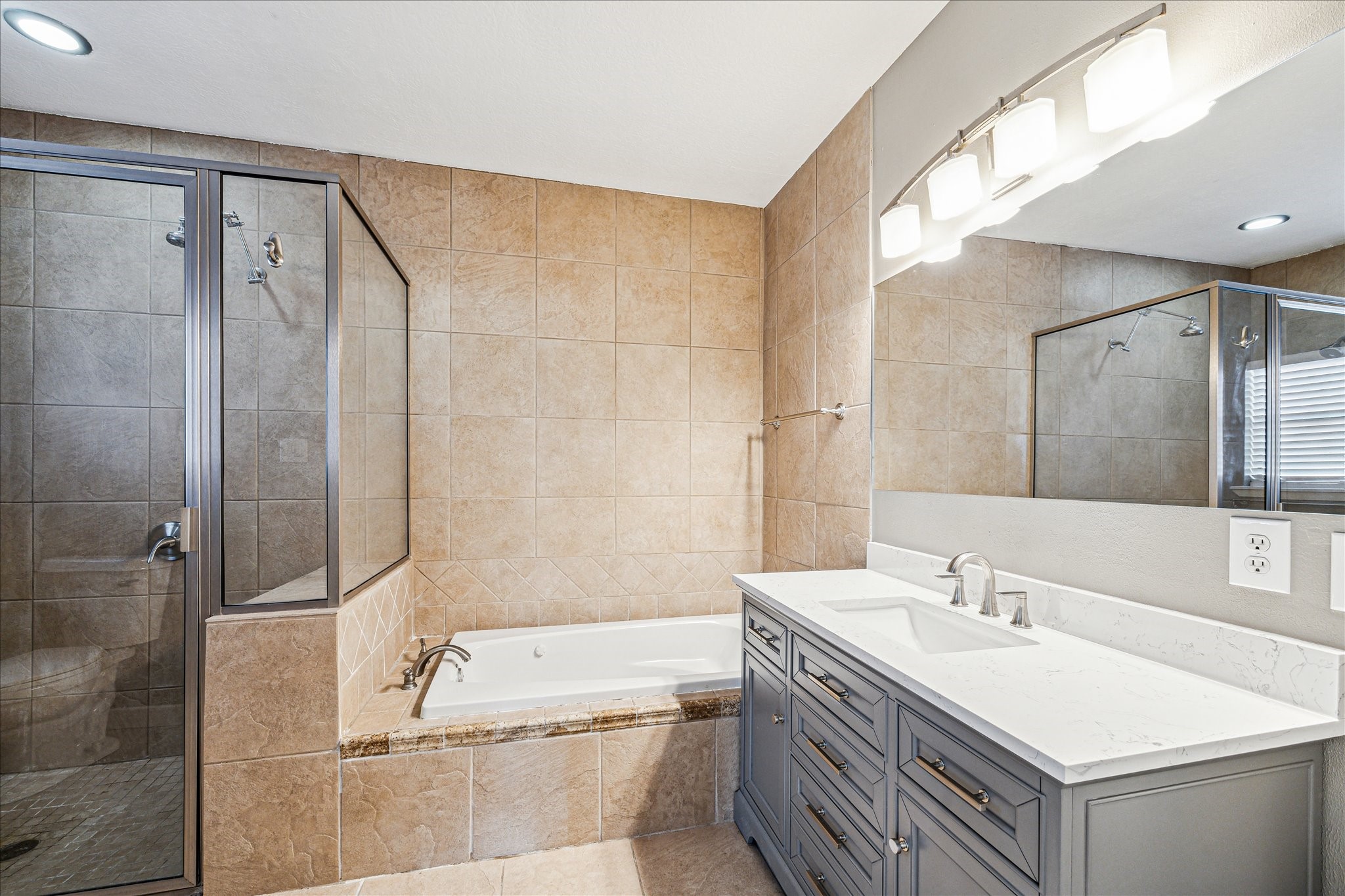 146 Dawns Edge Conroe, TX 77356 - Photo 22 of 39 a bathroom with a sink double vanity mirror and a bathtub
