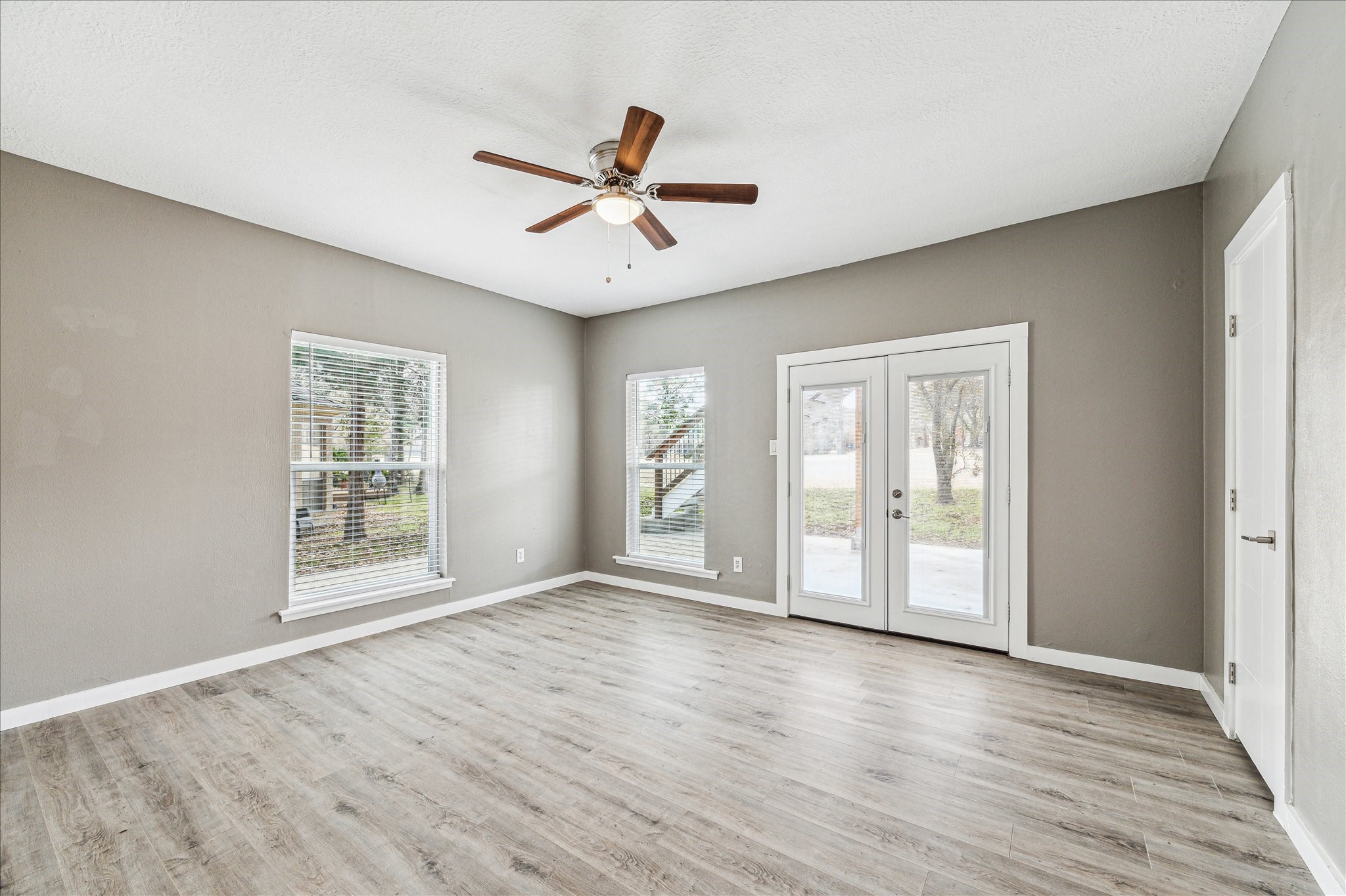 146 Dawns Edge Conroe, TX 77356 - Photo 24 of 39 a view of an empty room with wooden floor and a window