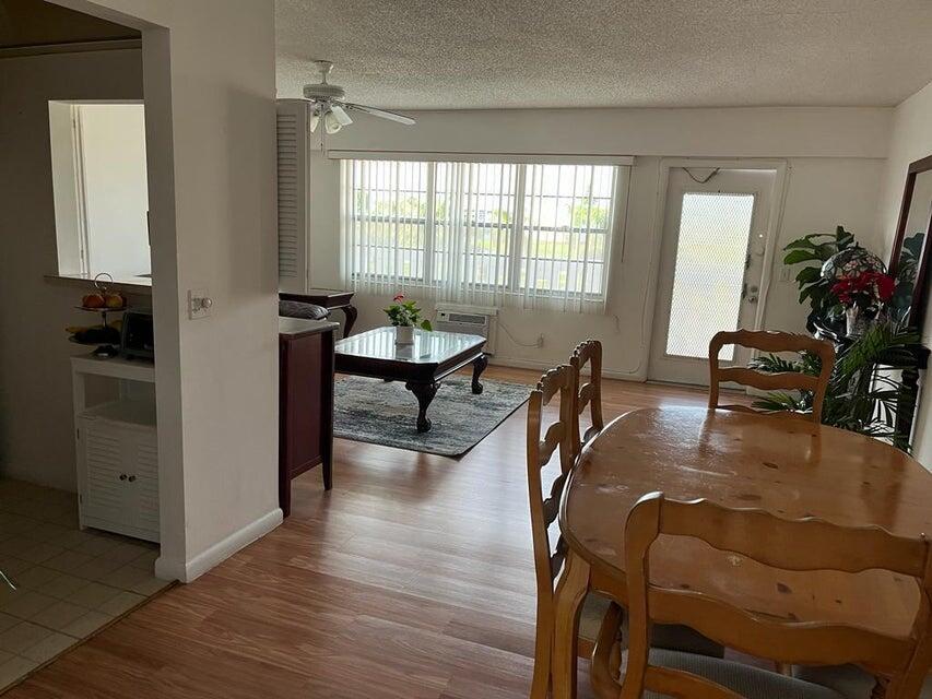 622 Fanshaw O, Unit 622 Boca Raton, FL 33434 - Photo 2 of 5 a workspace with furniture hardwood and a window