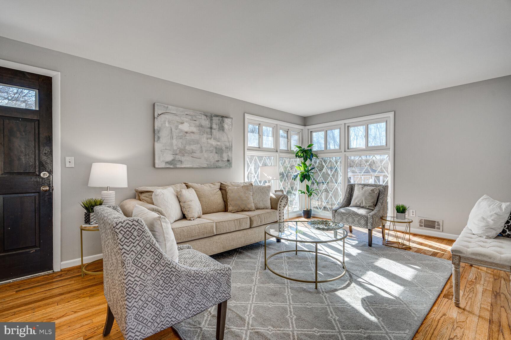 4310 Robert Court Silver Spring, MD 20906 - Photo 2 of 18 a living room with furniture a dining table and a potted plant