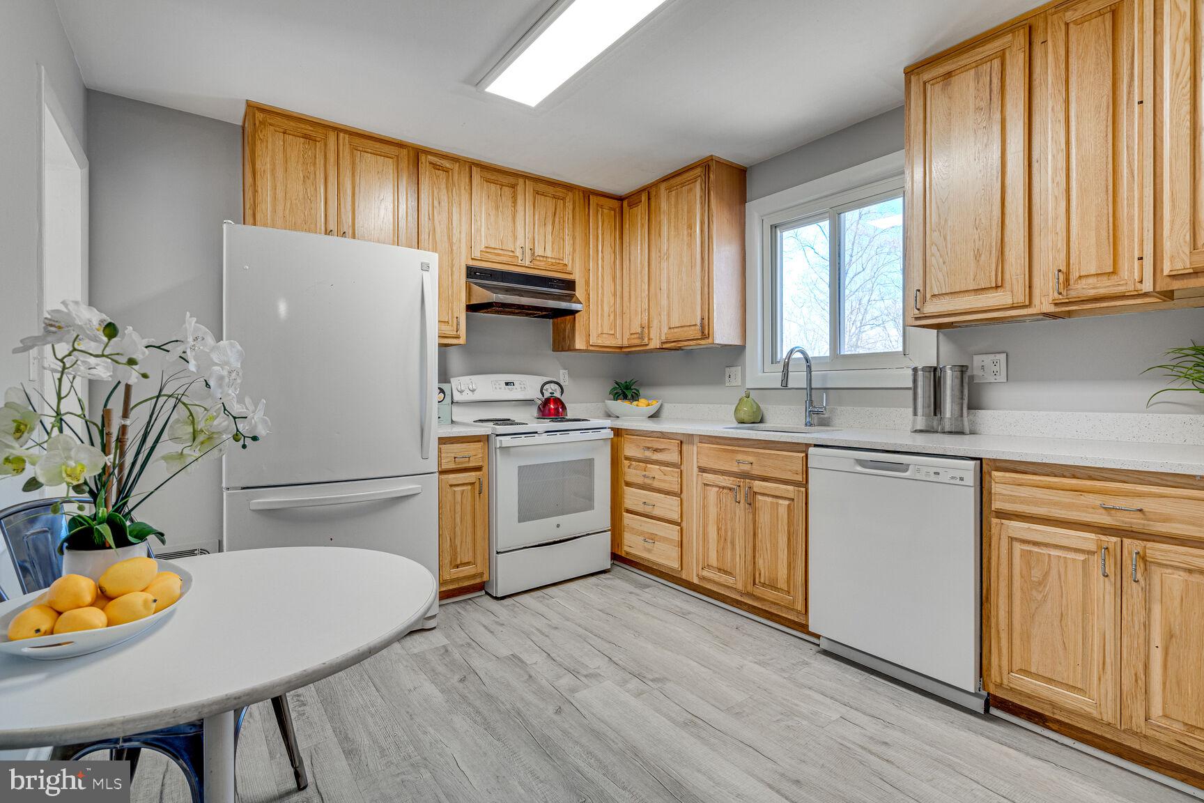 4310 Robert Court Silver Spring, MD 20906 - Photo 3 of 18 a kitchen with appliances a sink cabinets and a window