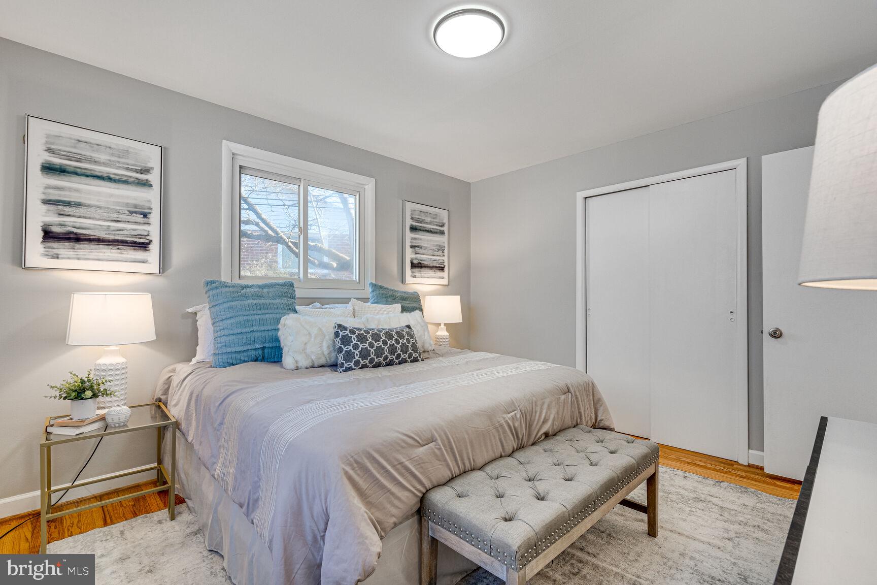 4310 Robert Court Silver Spring, MD 20906 - Photo 8 of 18 a bedroom with a bed and wooden floor