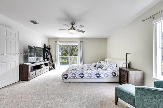 a bedroom with bed and a flat screen tv