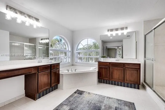 a large bathroom with a large tub and sink