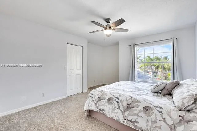 a bathroom with a sink a toilet a mirror and shower