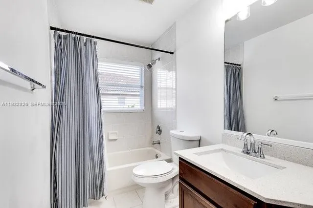 a room with a bed and a ceiling fan