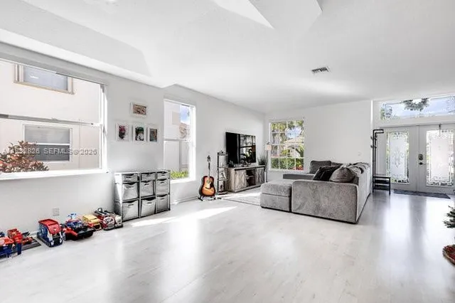 a living room with furniture and wooden floor