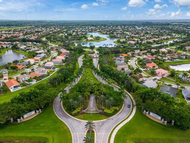 an aerial view of a house with swimming pool and garden view