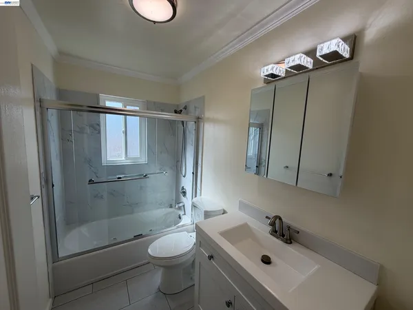 a bathroom with a toilet sink and shower