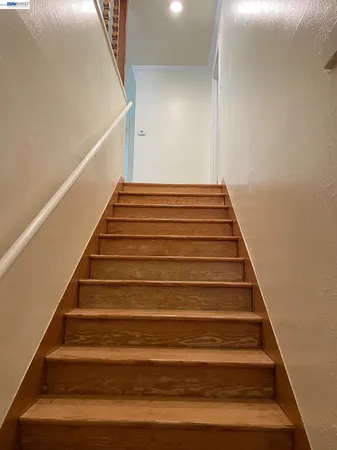 a view of a hallway with wooden floor and closet area