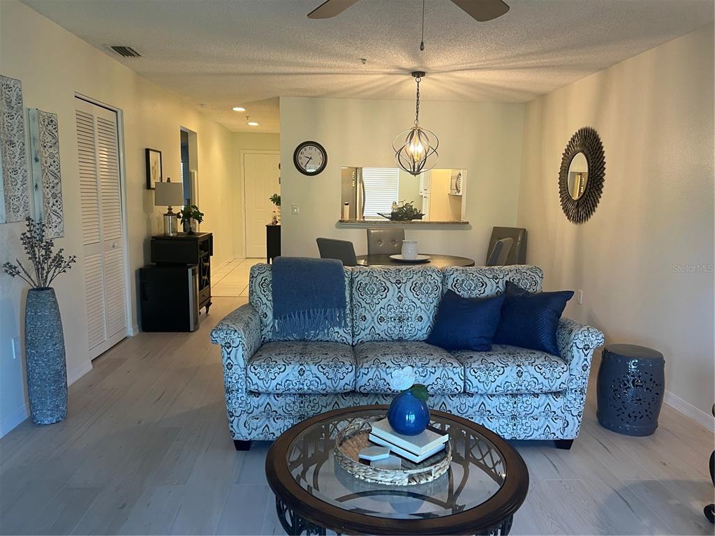 6501 Stone River Road, Unit 309 Bradenton, FL 34203 - Photo 14 of 30 a living room with furniture and a chandelier