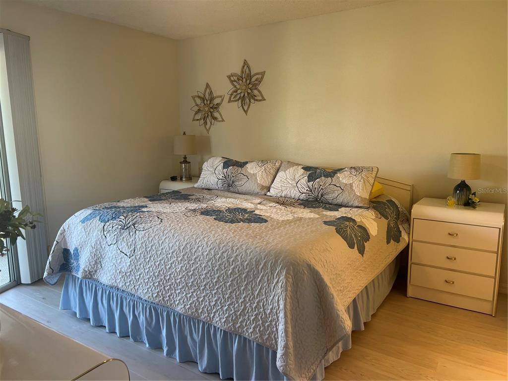 6501 Stone River Road, Unit 309 Bradenton, FL 34203 - Photo 19 of 30 a bedroom with a bed and a night stand