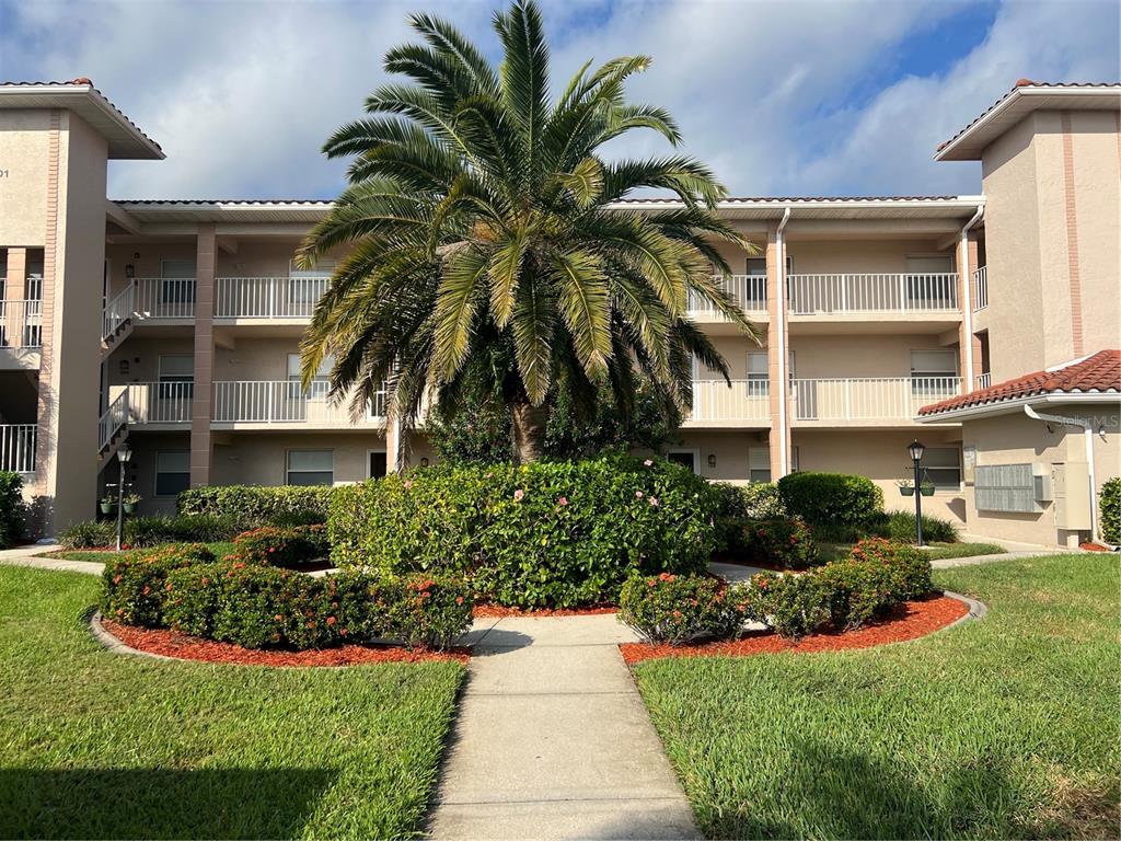 6501 Stone River Road, Unit 309 Bradenton, FL 34203 - Photo 2 of 30 a front view of a house with a garden