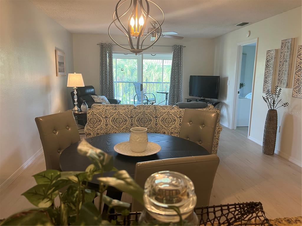 6501 Stone River Road, Unit 309 Bradenton, FL 34203 - Photo 21 of 30 a living room with furniture and a flat screen tv