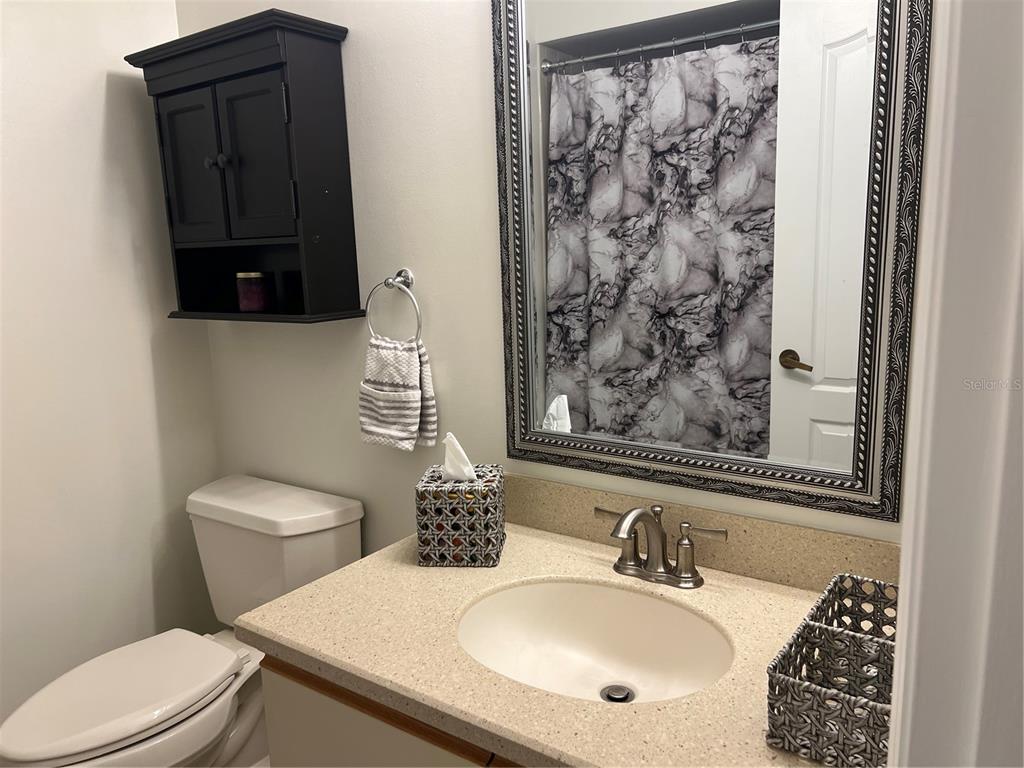 6501 Stone River Road, Unit 309 Bradenton, FL 34203 - Photo 28 of 30 a bathroom with a sink toilet and mirror