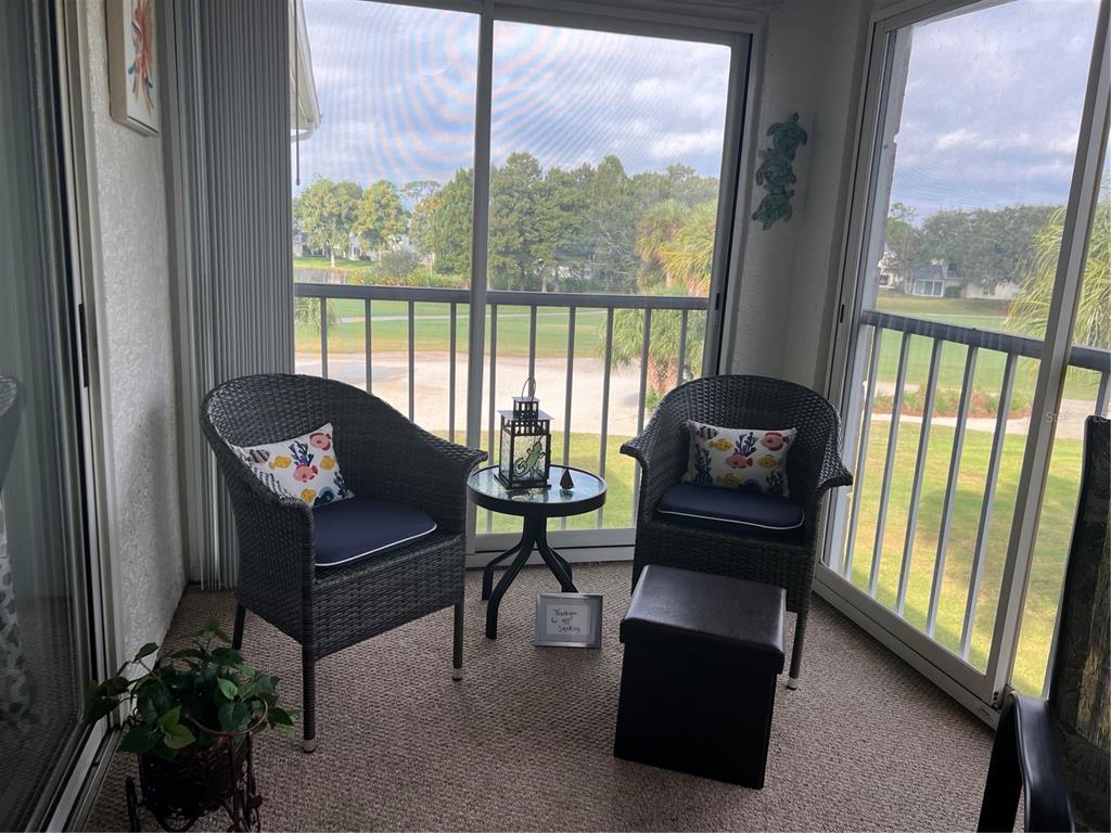 6501 Stone River Road, Unit 309 Bradenton, FL 34203 - Photo 30 of 30 a living room with furniture and a floor to ceiling window