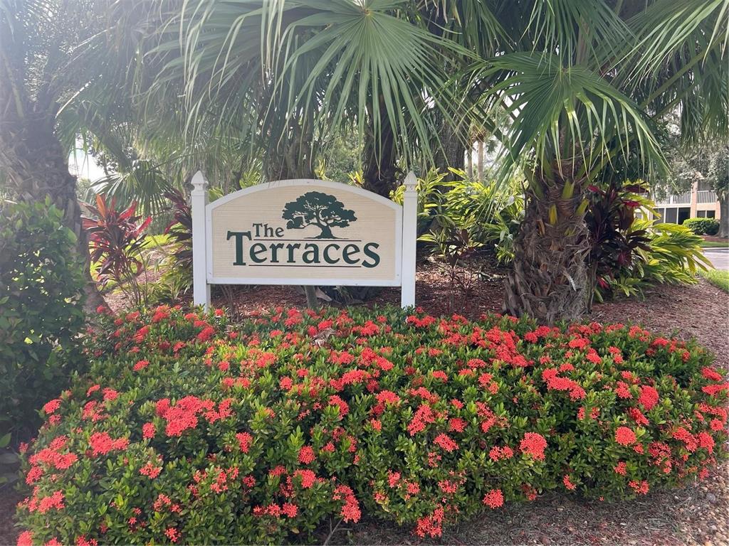 6501 Stone River Road, Unit 309 Bradenton, FL 34203 - Photo 8 of 30 a sign that is in front of flowers