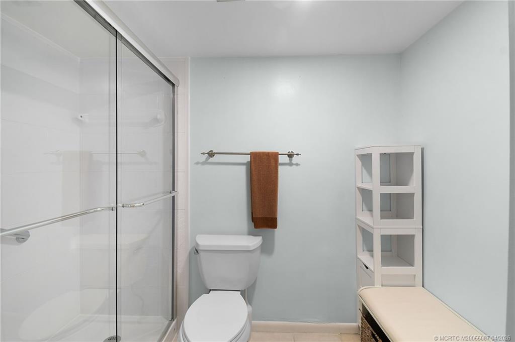 529 Northeast Plantation Road, Unit 105 Jensen Beach, FL 34957 - Photo 23 of 36 a bathroom with a toilet and a shower