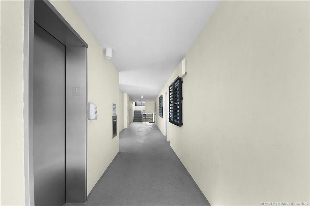 529 Northeast Plantation Road, Unit 105 Jensen Beach, FL 34957 - Photo 26 of 36 a view of a hallway with wooden floor