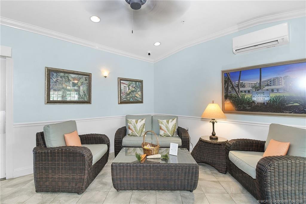 529 Northeast Plantation Road, Unit 105 Jensen Beach, FL 34957 - Photo 28 of 36 a living room with furniture and a lamp