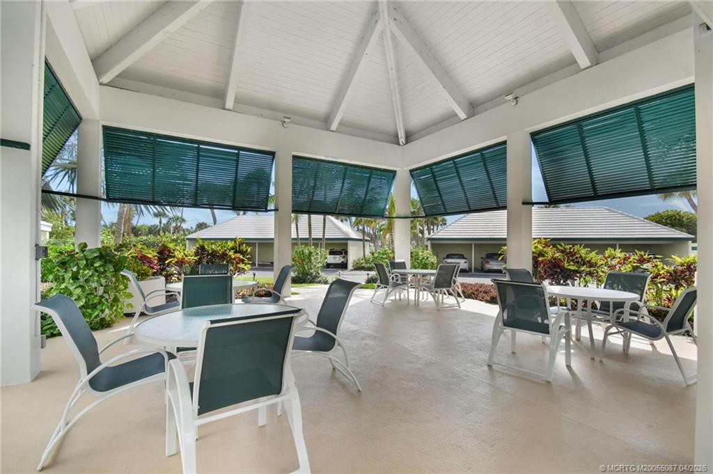 529 Northeast Plantation Road, Unit 105 Jensen Beach, FL 34957 - Photo 33 of 36 a view of a dining room with furniture window and outside view