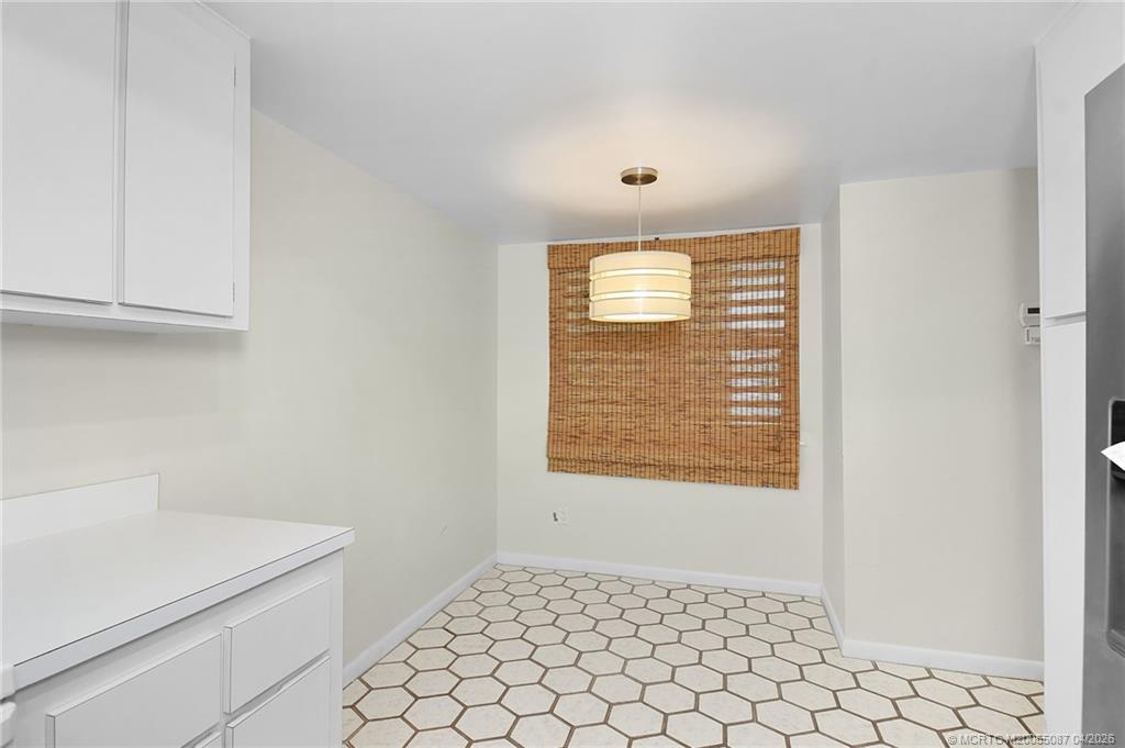 529 Northeast Plantation Road, Unit 105 Jensen Beach, FL 34957 - Photo 9 of 36 a view of an empty room and window