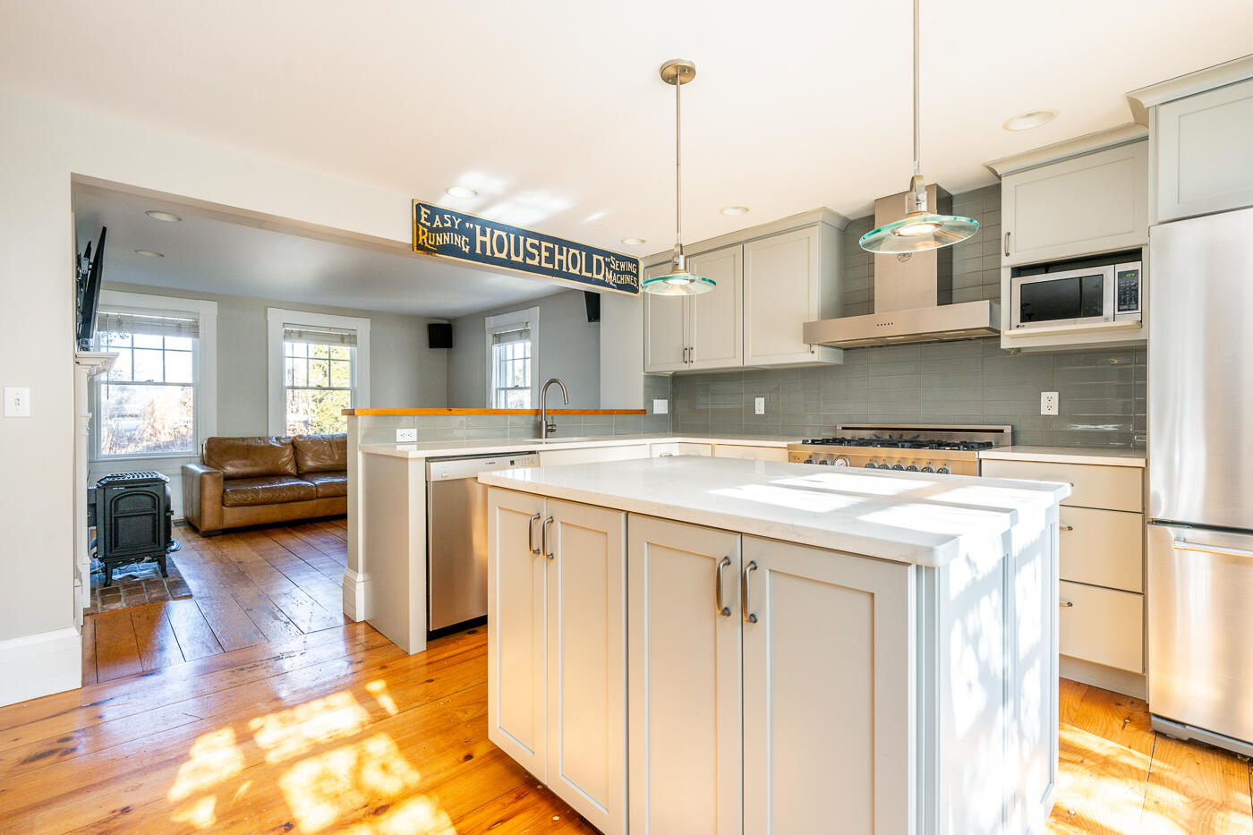 223 Main Street Wellfleet, MA 02667 - Photo 11 of 70 a kitchen with stainless steel appliances granite countertop a stove a sink and a refrigerator