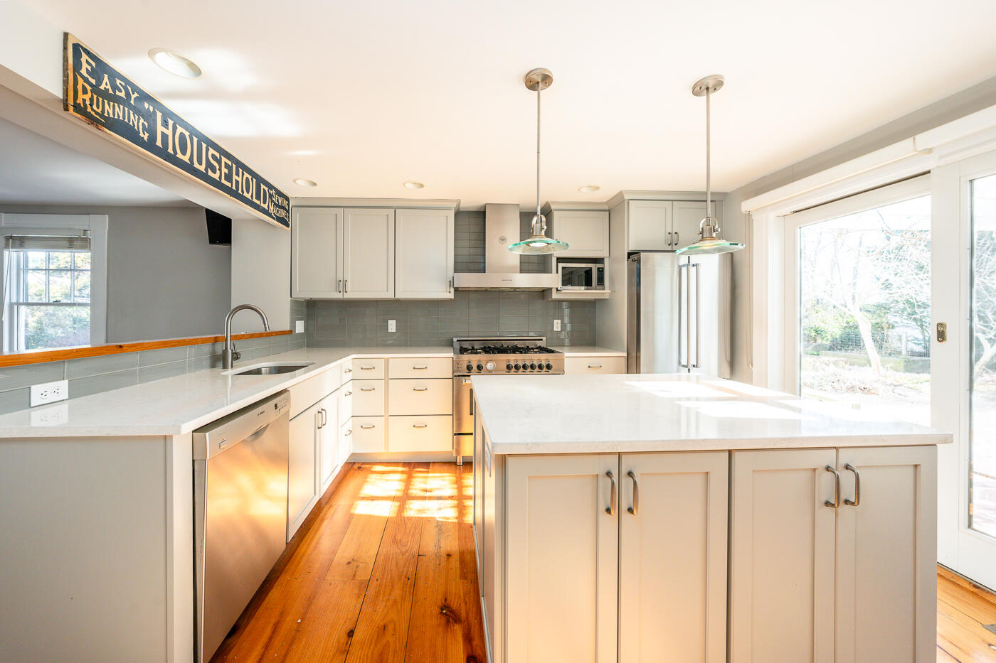 223 Main Street Wellfleet, MA 02667 - Photo 12 of 70 a kitchen with stainless steel appliances granite countertop a sink and a wooden floor