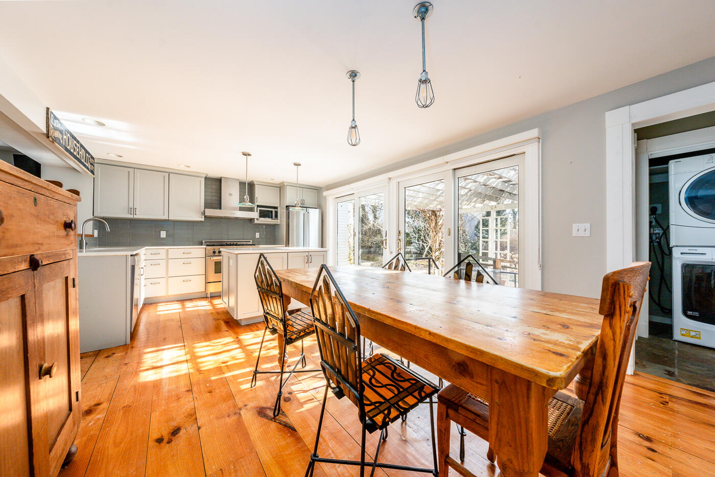 223 Main Street Wellfleet, MA 02667 - Photo 18 of 70 a dining room with stainless steel appliances kitchen island granite countertop a table and chairs