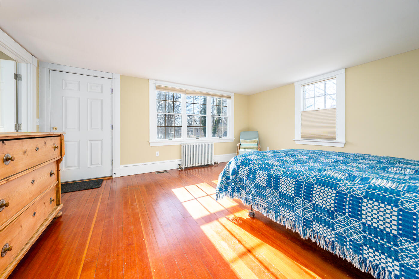 223 Main Street Wellfleet, MA 02667 - Photo 30 of 70 a bedroom with a bed and wooden floor