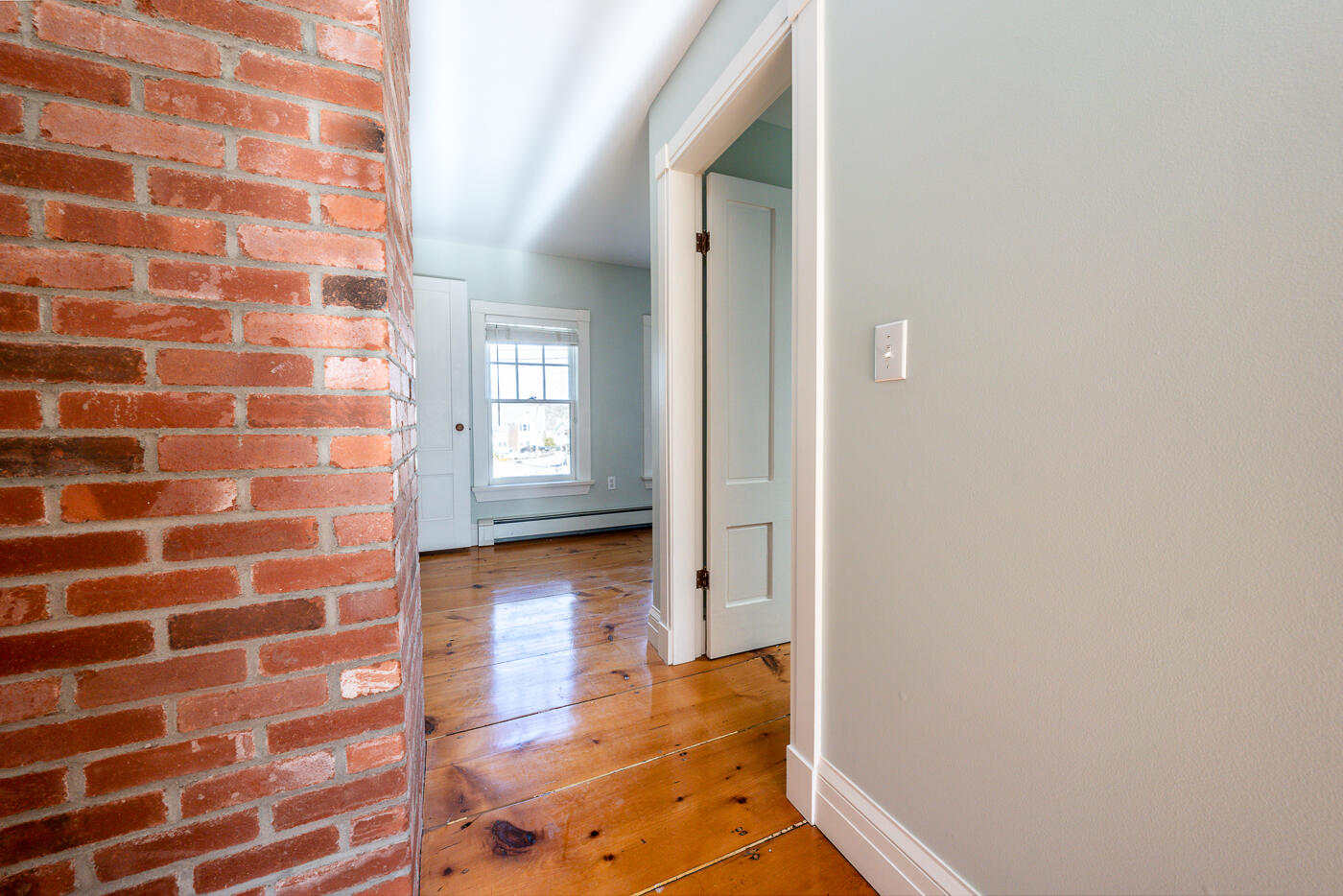 223 Main Street Wellfleet, MA 02667 - Photo 52 of 70 a view of a hallway with wooden floor and windows