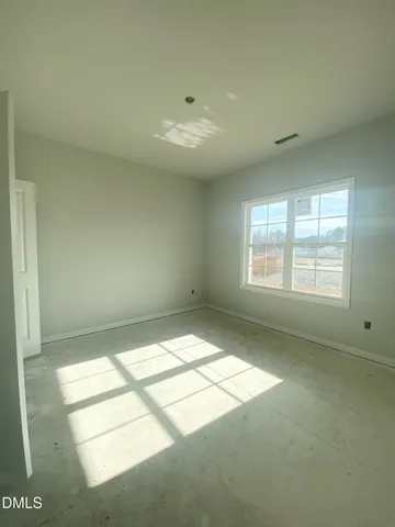 a bedroom with a bed and a mirror