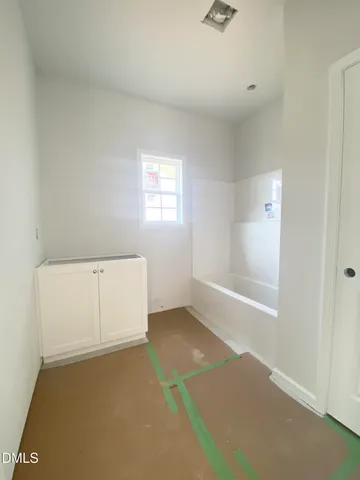 a view of an empty room and a window