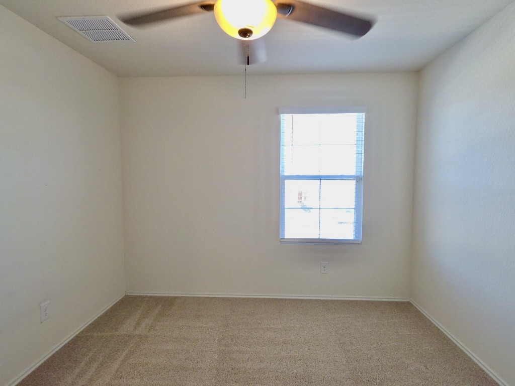 13525 Open Wagon Trail Elgin, TX 78621 - Photo 16 of 26 Bedroom with light colored carpet and a ceiling fan