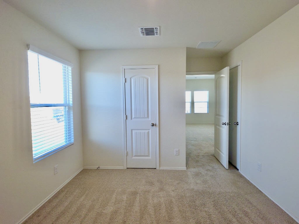 13525 Open Wagon Trail Elgin, TX 78621 - Photo 21 of 26 Bedroom with light carpet and a closet