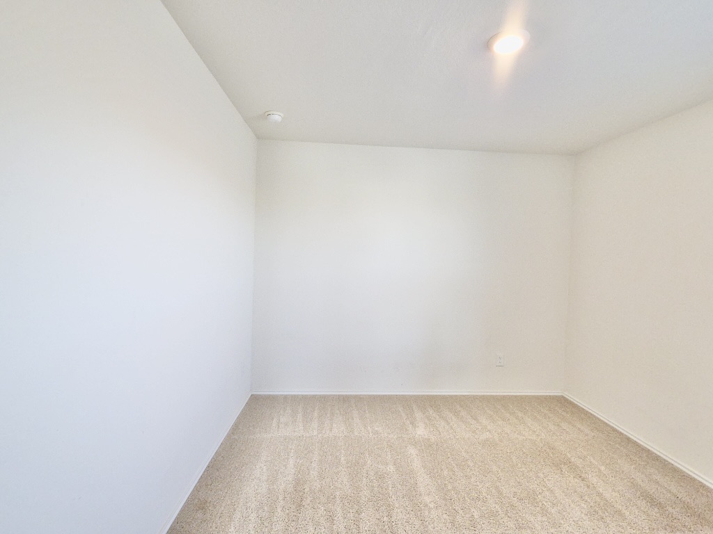 13525 Open Wagon Trail Elgin, TX 78621 - Photo 22 of 26 Bedroom featuring light carpet and baseboards