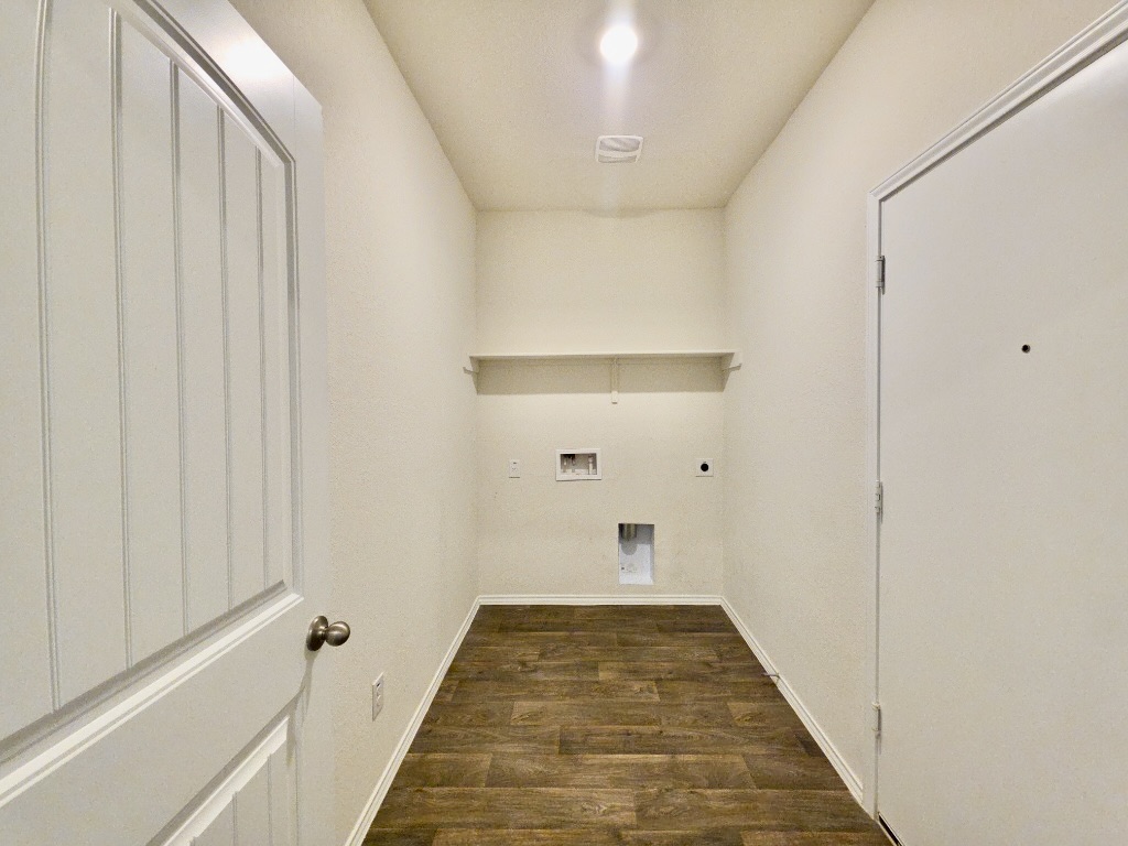 13525 Open Wagon Trail Elgin, TX 78621 - Photo 24 of 26 Laundry area with dark wood-style floors, electric dryer hookup, and washer hookup