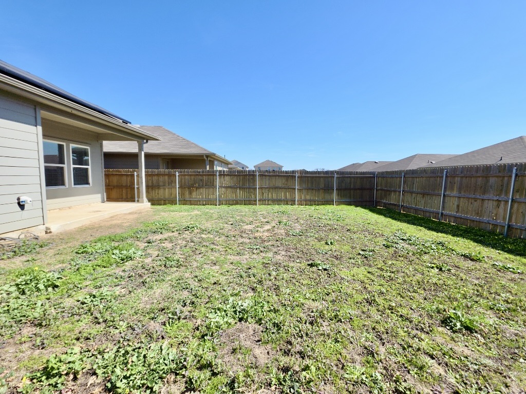 13525 Open Wagon Trail Elgin, TX 78621 - Photo 26 of 26 Fenced backyard featuring a patio