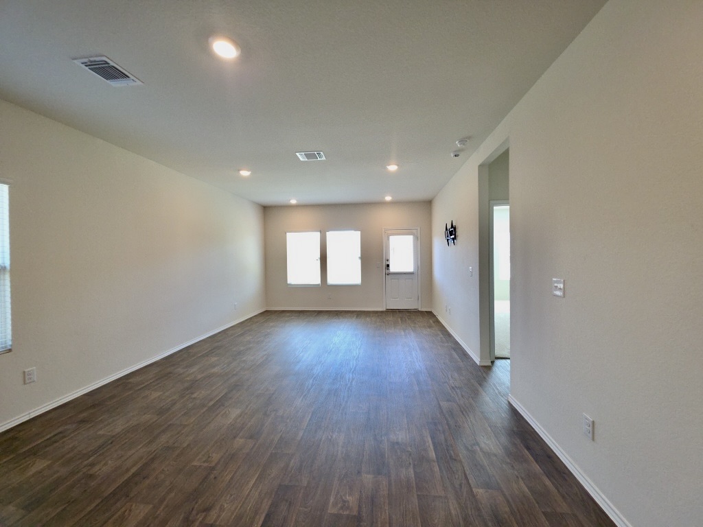 13525 Open Wagon Trail Elgin, TX 78621 - Photo 5 of 26 Living room with dark wood-style flooring and recessed lighting