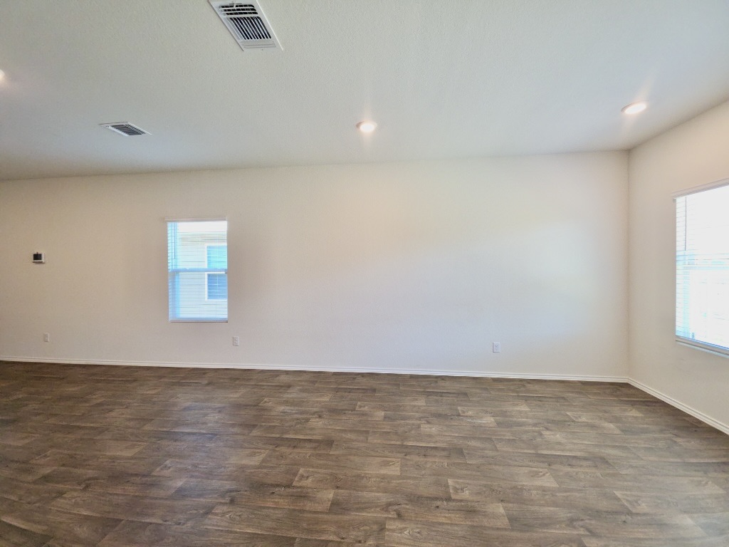 13525 Open Wagon Trail Elgin, TX 78621 - Photo 6 of 26 Living room with dark wood-style flooring, recessed lighting, and healthy amount of natural light