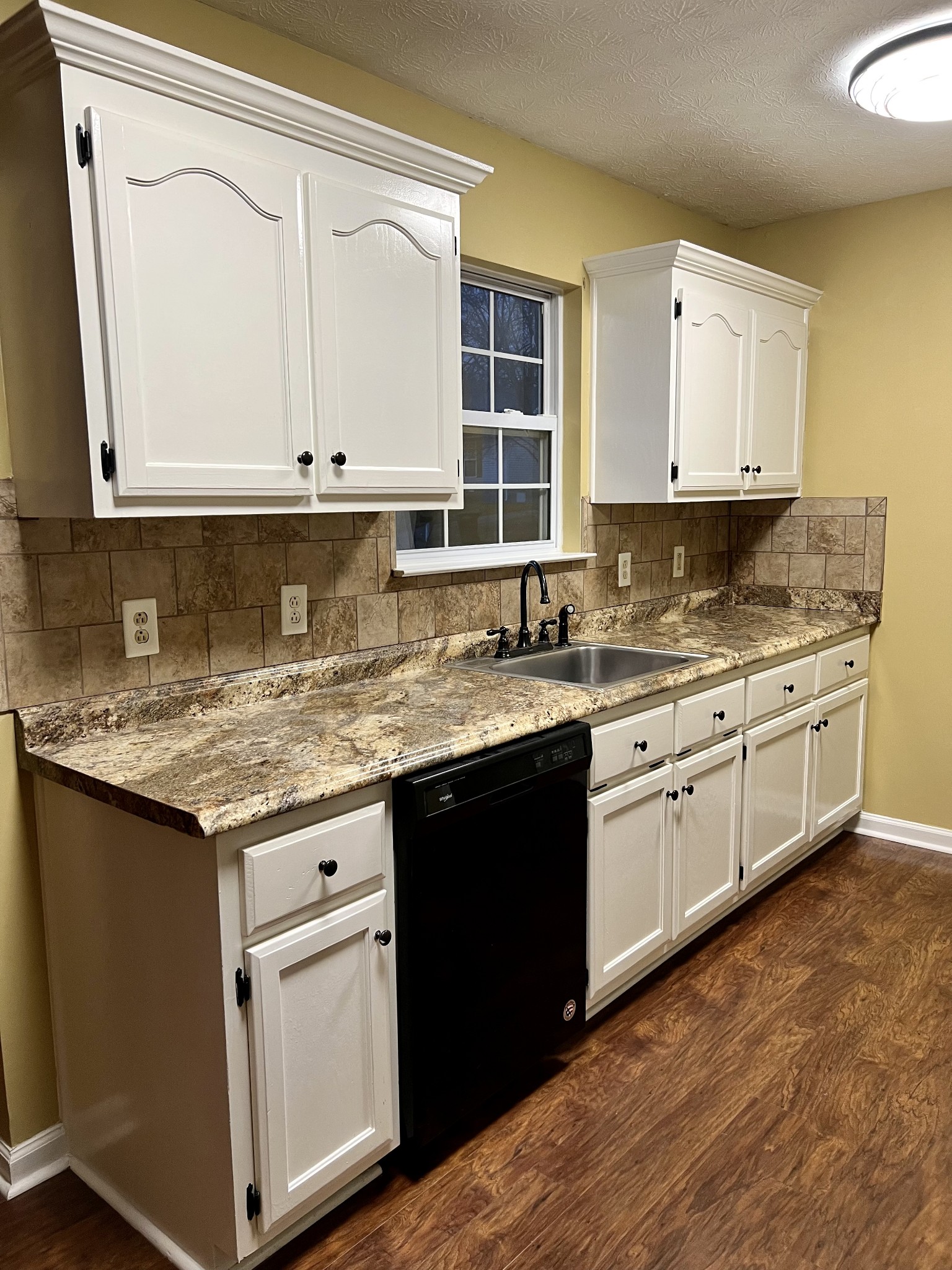 362 Bandera Lane Springfield, TN 37172 - Photo 6 of 16 a kitchen with granite countertop a sink cabinets and wooden floor