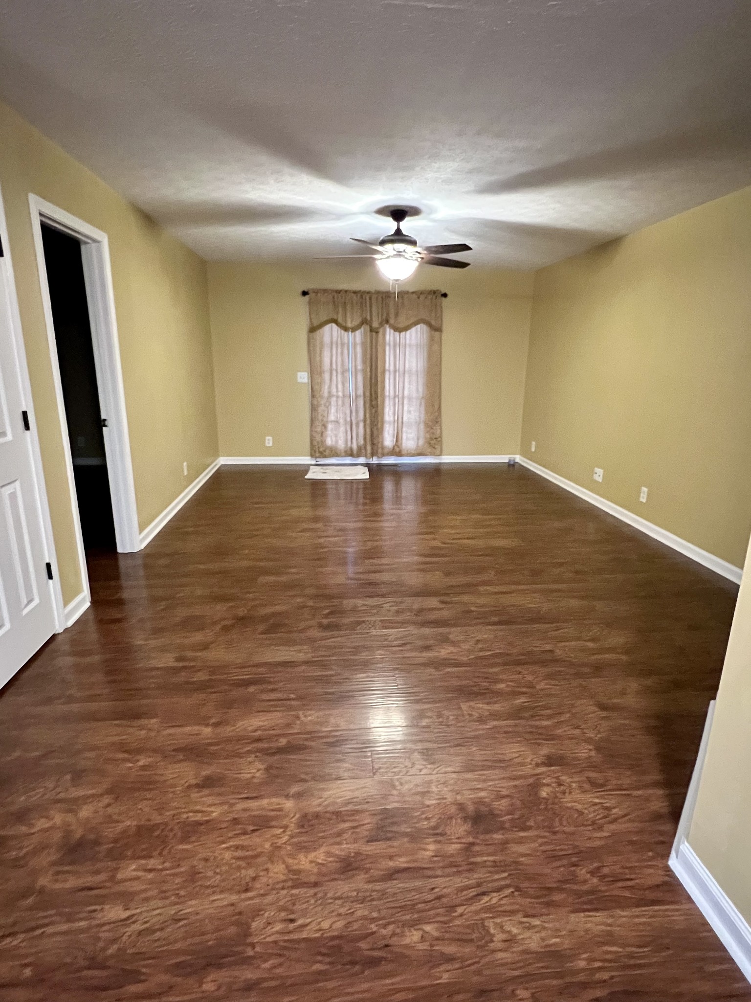 362 Bandera Lane Springfield, TN 37172 - Photo 8 of 16 a view of empty room with wooden floor and fan