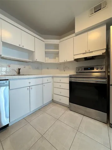 a kitchen with cabinets appliances and a sink