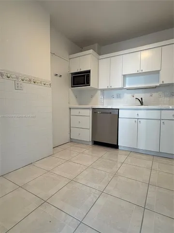 a kitchen with cabinets and appliances