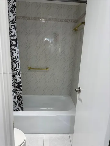 a bathroom with a bathtub and shower
